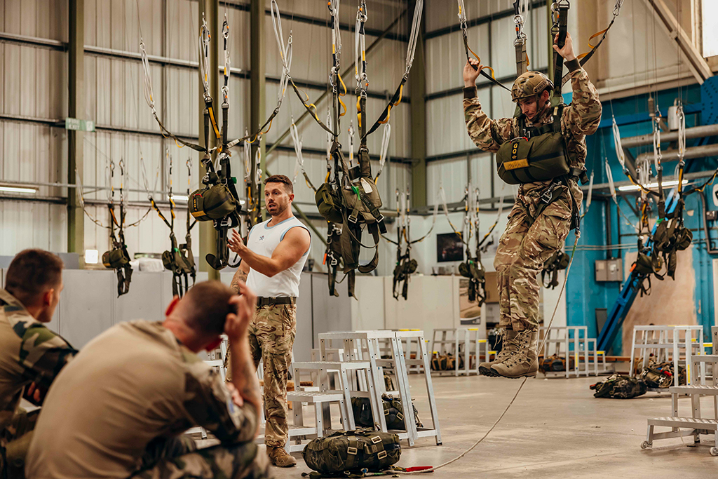 Instructor led training. Parachutists learn how to prepare for landing under a British Low Level Parachute system.